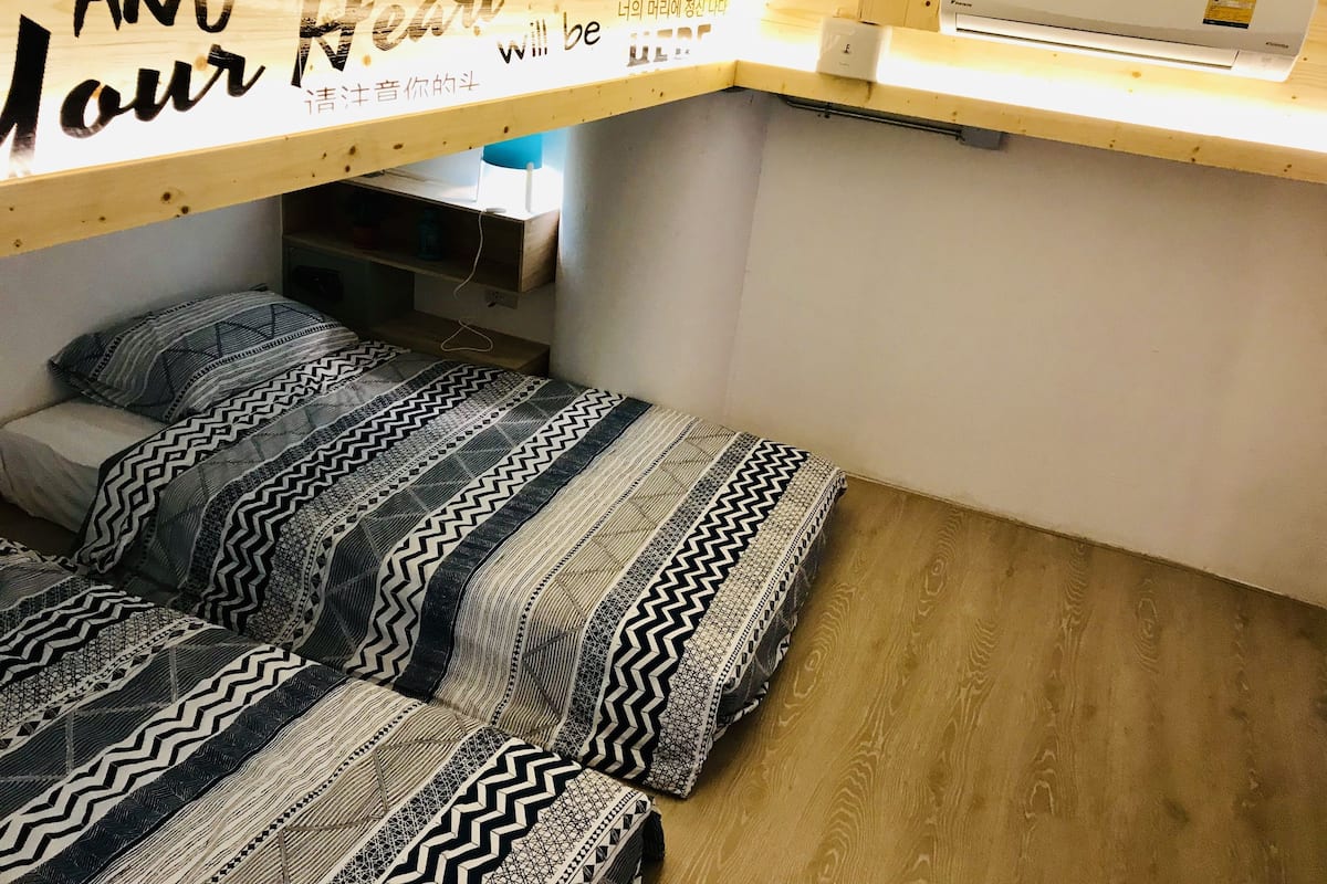 A small, compact room with a bunk bed and a desk area.