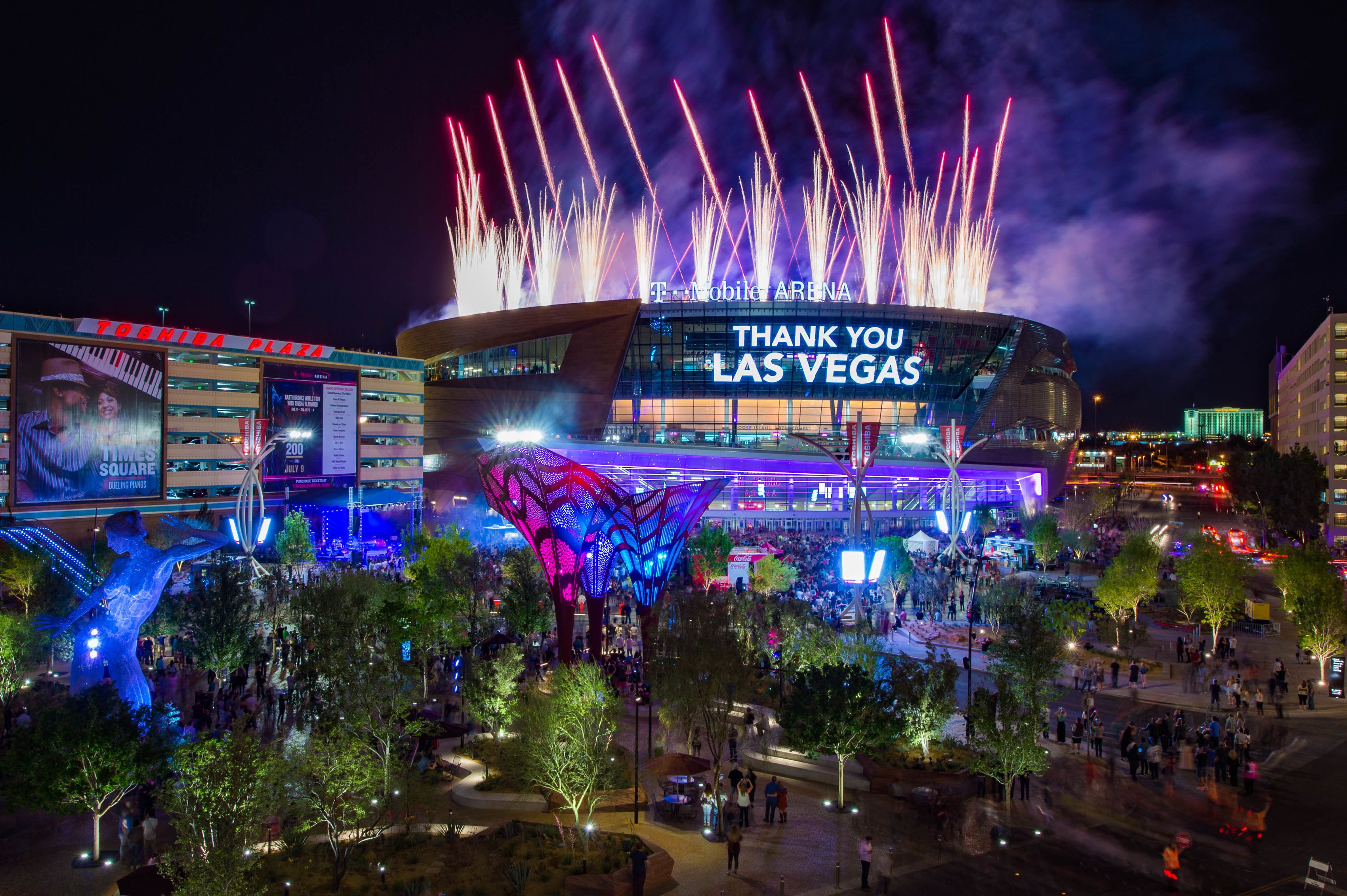 A brightly lit building with a large digital sign saying "THANK YOU LAS VEGAS" and fireworks in the background.