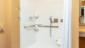 A modern bathroom with a shower, toilet, and sink.