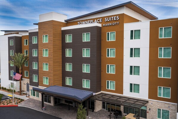 A multi-story hotel with a modern design, featuring a covered entrance and outdoor seating area. - TownePlace Suites By Marriott Las Vegas Stadium District (Las Vegas)