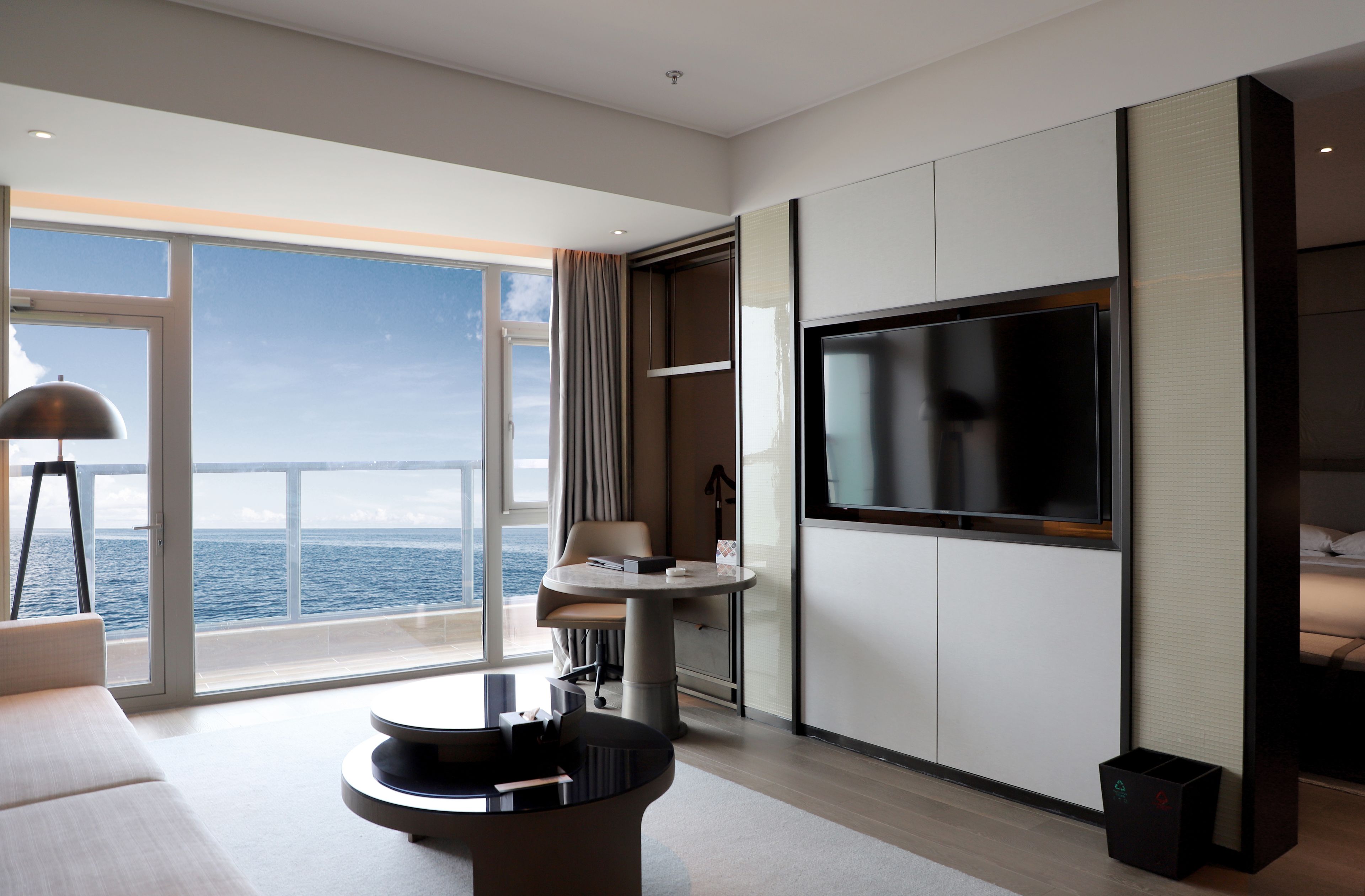 junior suite, 1 king bed, ocean view | living area | 60-inch flat-screen tv with cable channels, tv