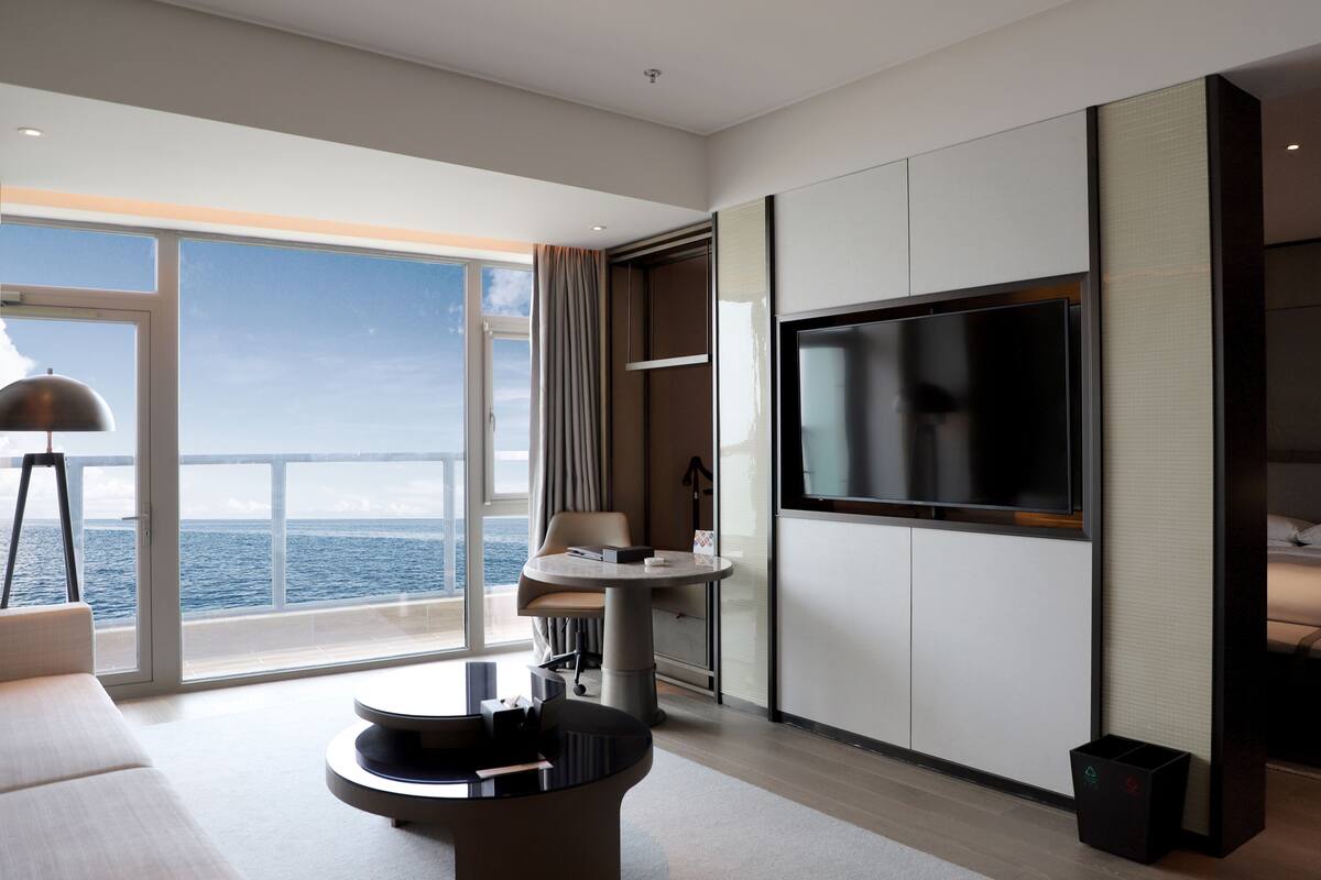 junior suite, 1 king bed, ocean view | living area | 60-inch flat-screen tv with cable channels, tv