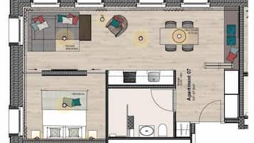 A floor plan of a hotel room with a bed, a desk, a chair, a sofa, and a small bathroom.