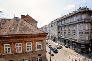 A street view with buildings, a crosswalk, and cars. - Virtus Apartments and Rooms (Zagreb)