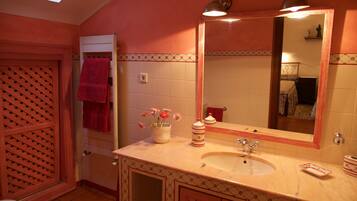 A bathroom with a sink, mirror, and toilet.