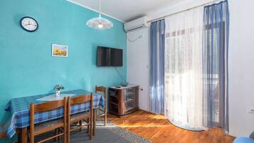 Comfort Apartment, Garden View | Living area | Flat-screen TV