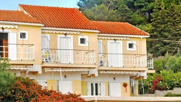A two-story building with balconies and a red-tiled roof. - Kappatos Apartments (Kefalonia)
