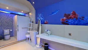 A modern bathroom with a blue wall mural, a white sink, and a toilet. - Xiamen Aizhu Lover Hotel - Jimei Branch (Xiamen)