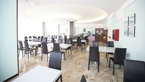 A spacious dining area with multiple tables and chairs, a marble floor, and framed pictures on the walls. - Hotel Mirage Bellaria (Bellaria-Igea Marina)