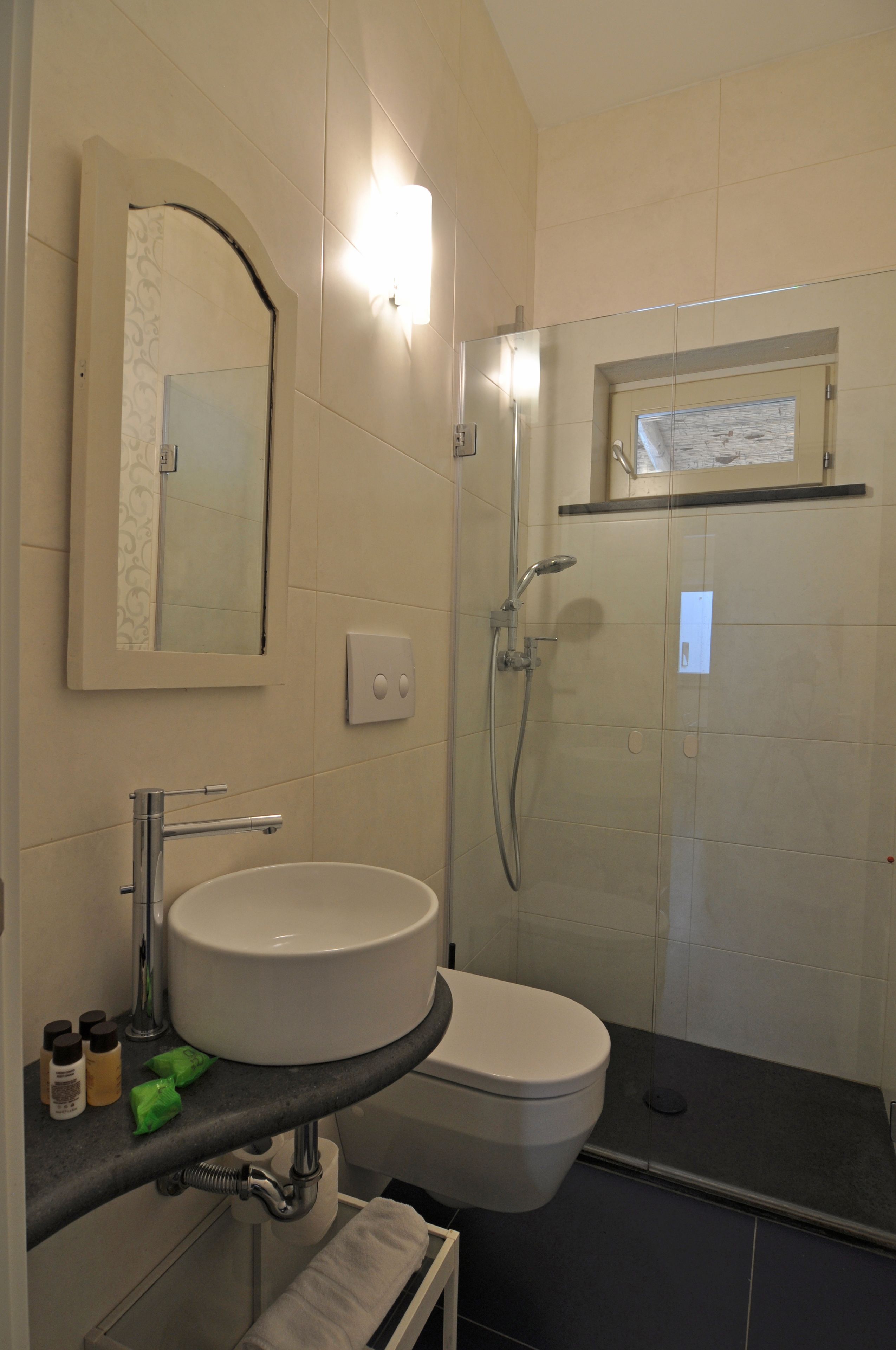 A bathroom with a sink, toilet, and shower.