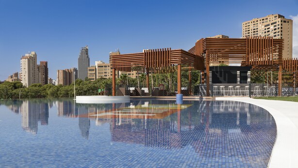 A modern pool area with a clear view of surrounding high-rise buildings. - Sunset Drive Mar Holidays (Benidorm)