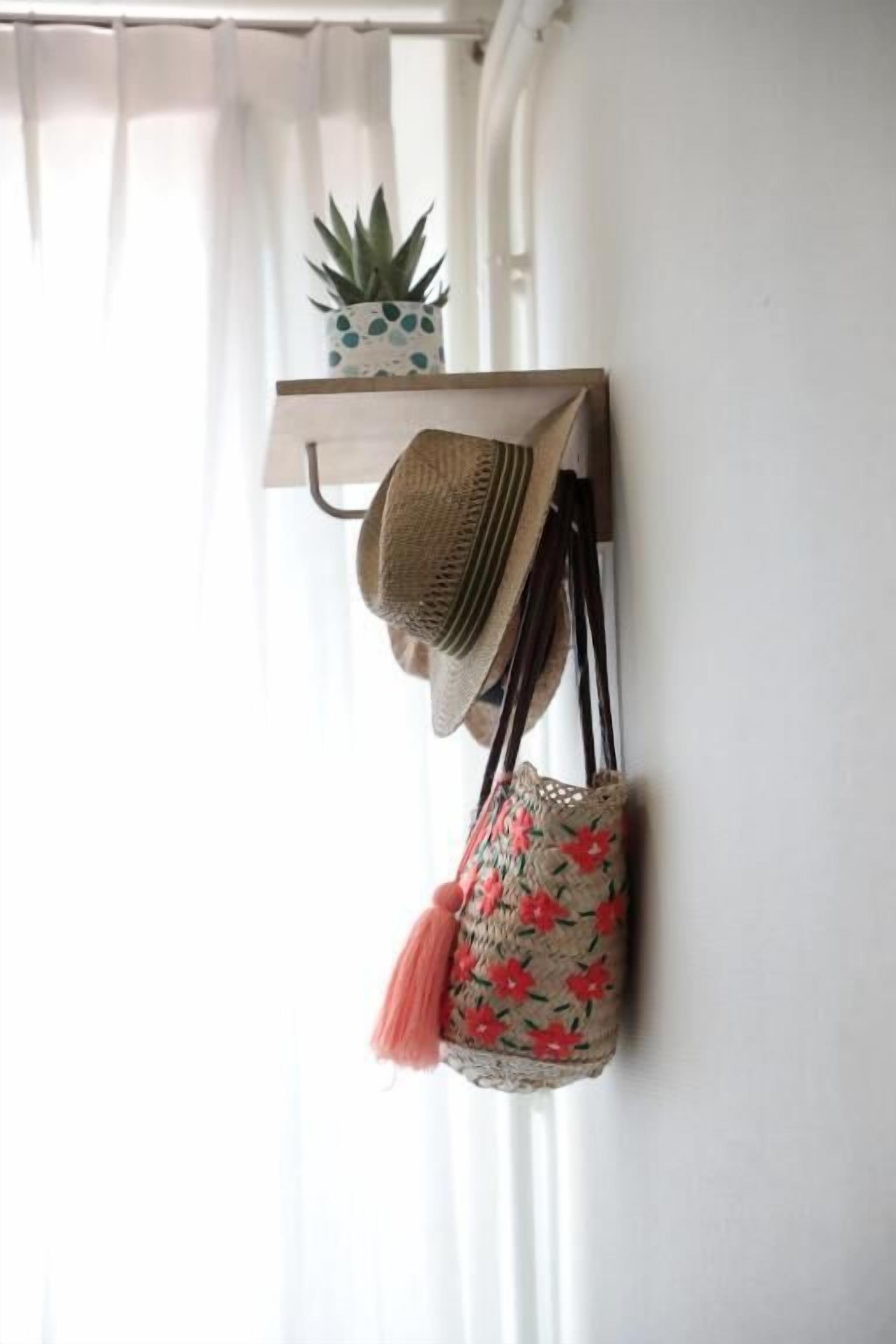 A wall-mounted shelf with a woven hat and a woven bag.