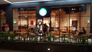 A Starbucks with a large logo, indoor seating, and a counter area. - Room with a sea and city view!!  (Lapu Lapu)