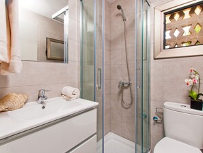Shower, hair dryer, towels, toilet paper