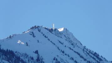 Una montaña cubierta de nieve con una torre alta en la cima.