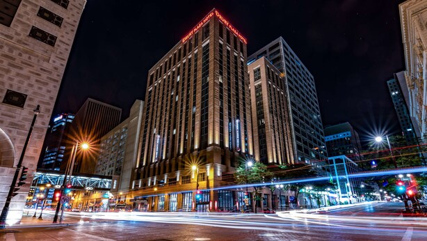A multi-story hotel with a prominent sign at the top.
