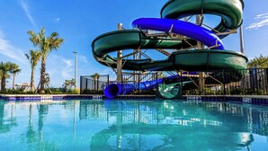 A swimming pool with a water slide structure.