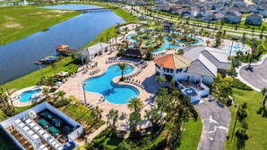 A resort with a large swimming pool, a golf course, and a residential area with houses.