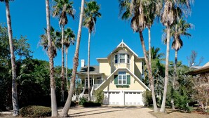 A two-story house with a gabled roof, a front porch, and a garage.