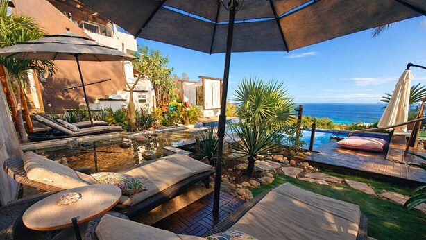 A poolside area with lounge chairs, a small pool, and a view of the ocean. - Casa Qi Mazunte (Santa María Tonameca)