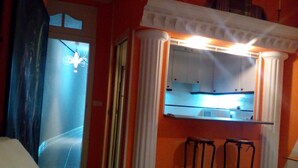 A kitchen with white cabinets, a countertop, and two stools. - GOYA-APARTMENT-ARTS (Madrid)