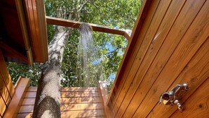 A wooden deck with a metal faucet and a showerhead. - Family fun... The star cabin (Deshaies)