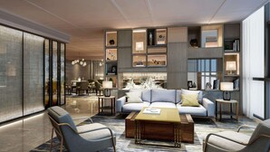 A modern hotel lobby with a seating area, a coffee table, and a fireplace. - Radisson Suzhou (Suzhou)