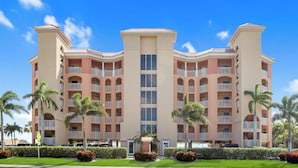 A multi-story hotel with a symmetrical facade, balconies, and a central entrance. - Surf Beach 402 - Spectacular Sunsets - Beach Front (Treasure Island)