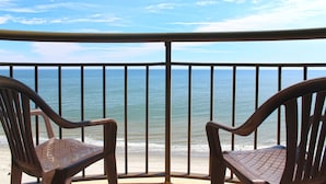 A balcony with two chairs facing a beach. - Meridian Plaza by Palmetto Vacations (Myrtle Beach)
