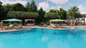 A swimming pool with lounge chairs and umbrellas, surrounded by palm trees and a clear sky. - Deluxe King Gulf View Rm 104 Apartment 1 (Holmes Beach)