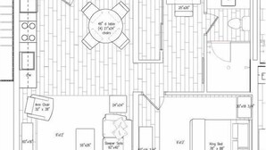 A floor plan of a hotel room with a king bed, two armchairs, a sofa, a dining table with four chairs, and a small bathroom. - Gulf Front Suite 201 Apartment 1 (Holmes Beach)
