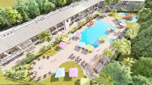 An aerial view of a resort with a central swimming pool, outdoor seating areas, and a building with multiple balconies. - Gulf View Room 102 Apartment 1 (Holmes Beach)