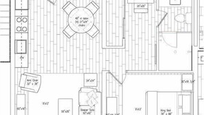 A floor plan of a hotel room with a kitchenette, a dining area, a king bed, a sleeper sofa, and two armchairs.