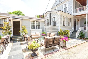 A patio with outdoor furniture, a stone pathway, and potted plants. - 154 ABC Spring Street - 7 BR / 5 BA Holiday home 7 (Charleston)