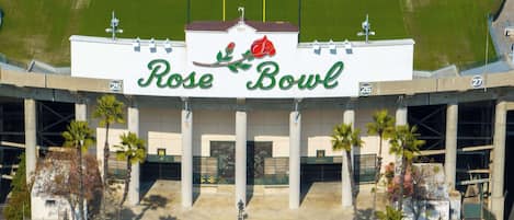 An aerial view of the Rose Bowl stadium with its distinctive architecture and entrance.