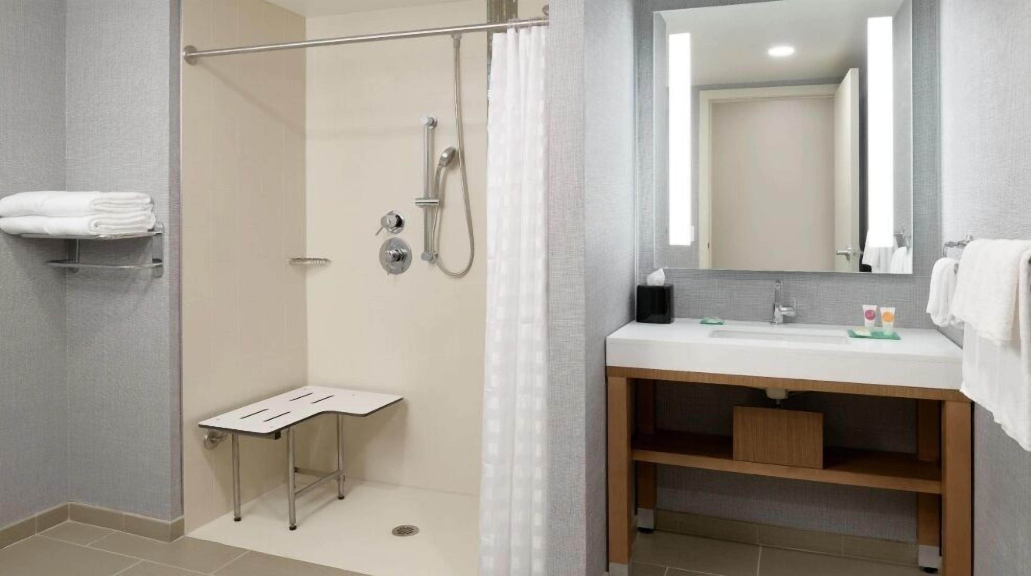 Un bagno moderno con doccia, servizi igienici e lavandino.