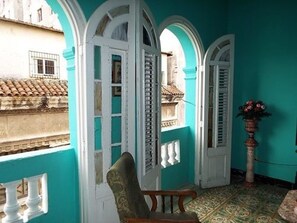 Relax in this inviting room with a balcony offering views of the surrounding cityscape.