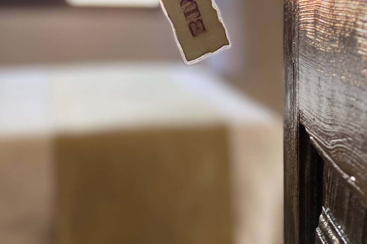 A close-up of a wooden door with a metal handle and a tag hanging from it.