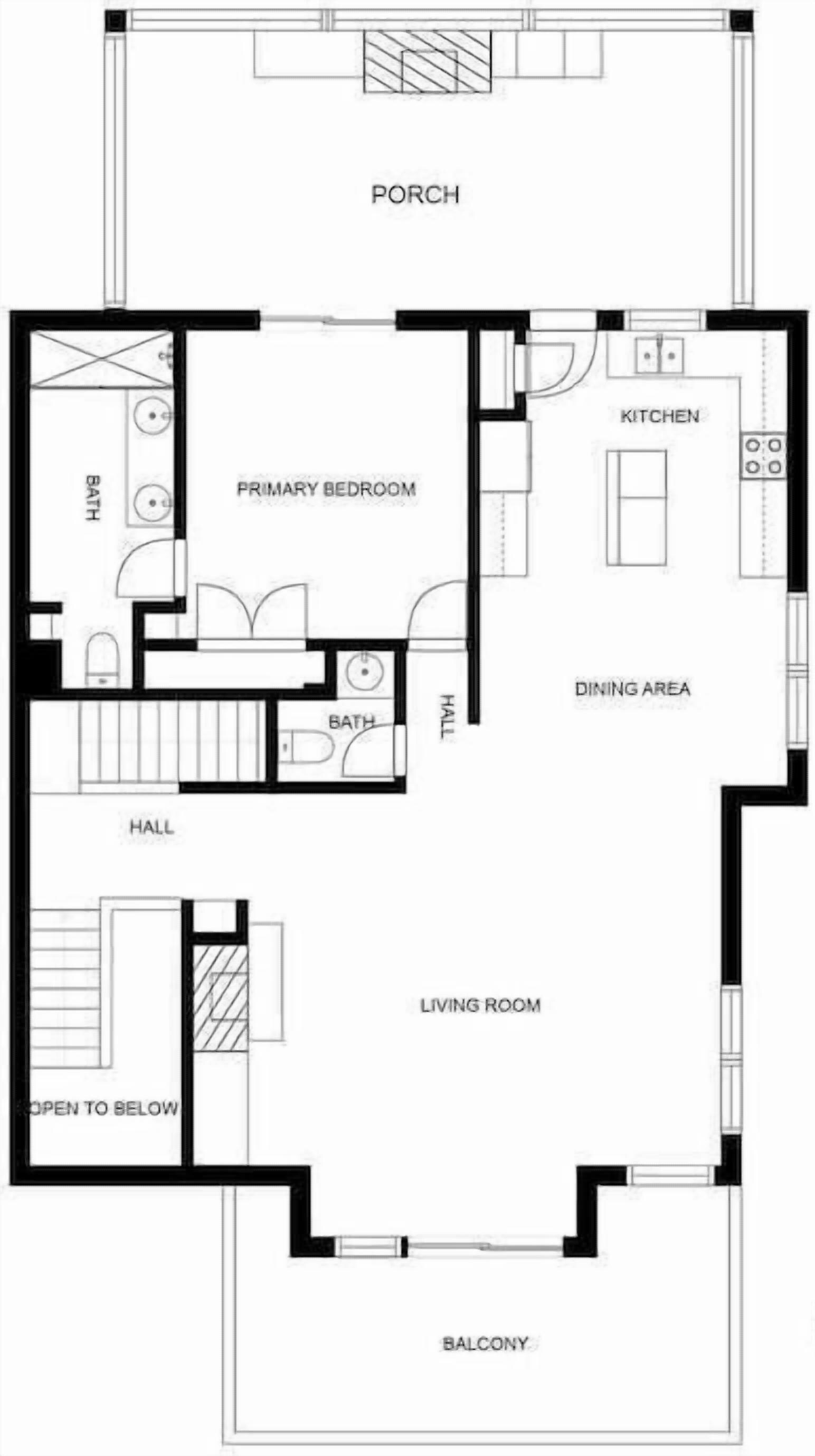 Un plan d’étage comprenant une chambre principale, une cuisine, un coin repas, un salon, un balcon et un hall d’entrée.