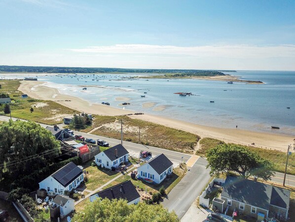 A coastal residential area with houses, a beach, and boats in the water. - Across from Mayo Beach walk to downtown! (Wellfleet)