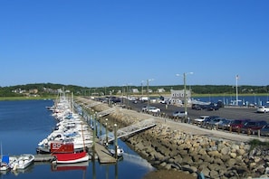 Stroll along the marina's pedestrian walkway, offering scenic views of the water and moored boats.
