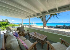 A covered outdoor seating area with a view of the beach and ocean. - Crabtree #1 - Amazing Beach -Walk to Restaurants (Cockburn Town)
