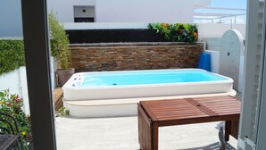 A small outdoor swimming pool with a wooden table in the foreground. - SEASIDE VILLA WITH PRIVATE SWIMMING POOL  (Manta Rota)