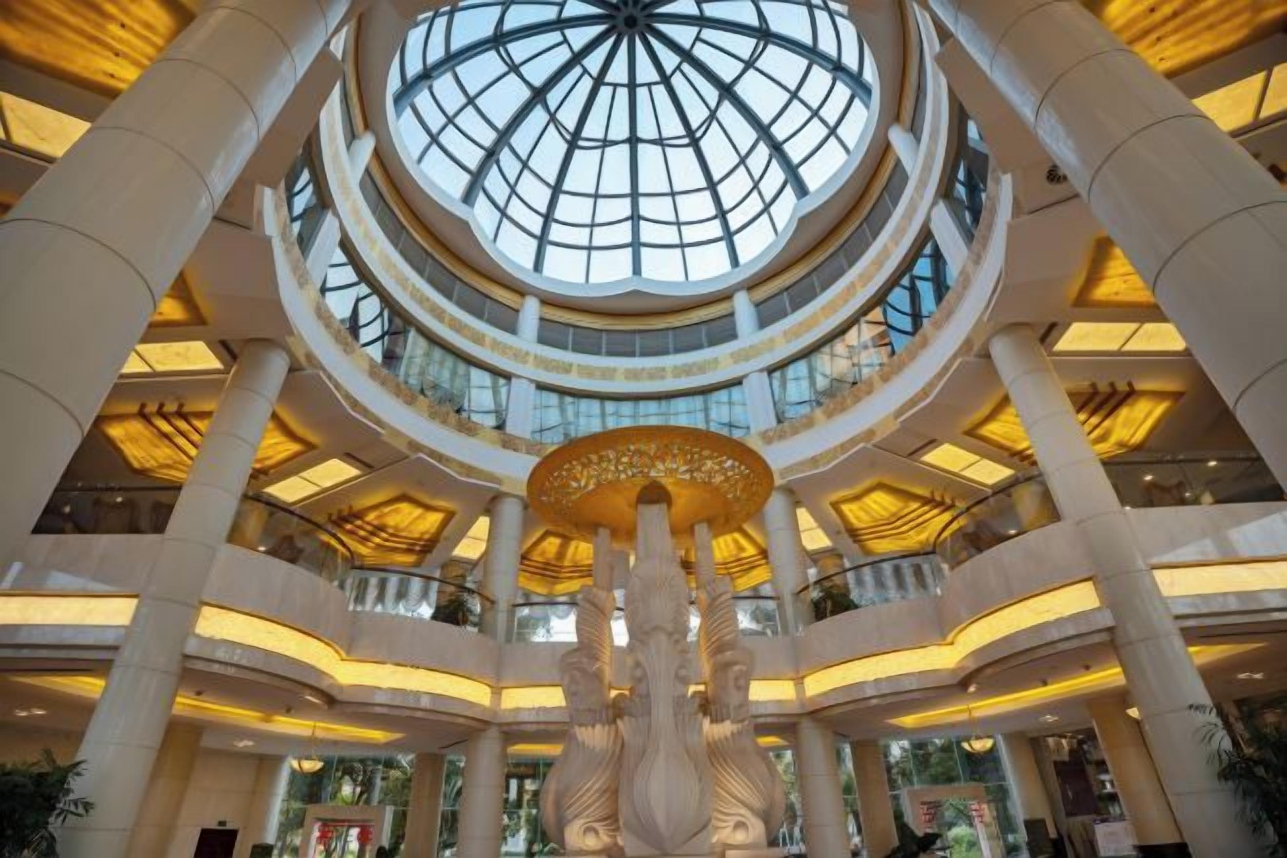 A multi-level atrium with a central column and a glass ceiling.