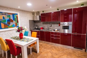 Enjoy cooking in this kitchen with a stove, oven, and dining table.