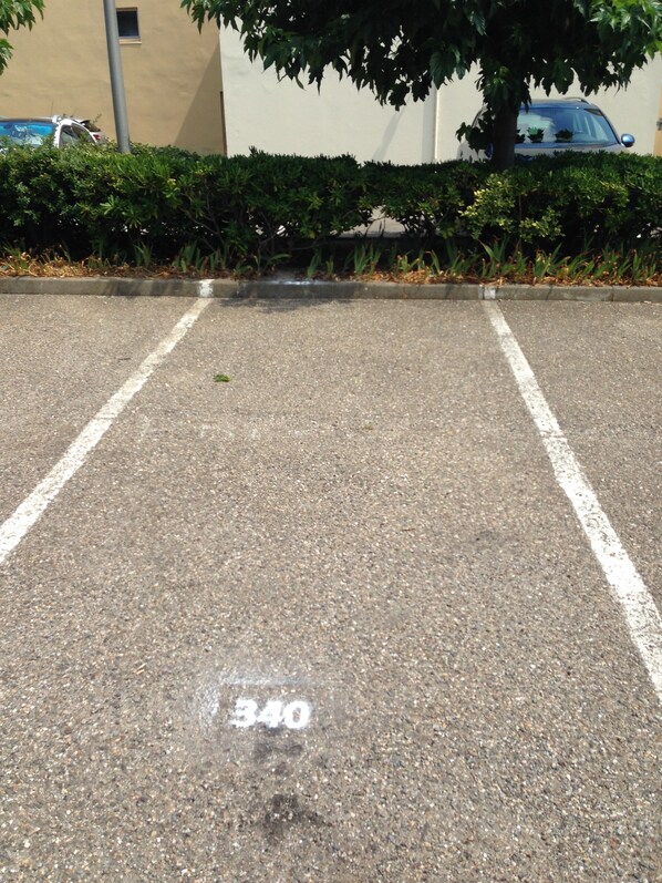 A parking lot with white lines marking parking spaces and a number '340' painted on the ground.