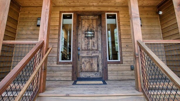A wooden cabin with a central door, two windows on either side, and a wooden staircase leading up to the entrance. - ⭐️Luxury newly built with Sauna, Steam and Hot Tub  (Truckee)
