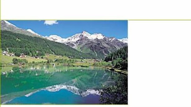 Paisaje de montaña con un lago tranquilo que refleja las montañas y el cielo.