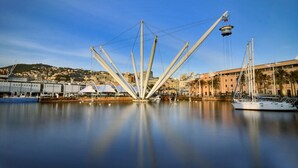 A waterfront view with a modern bridge structure, boats, and buildings along the shore. - Amazing seaview apartment Nervi - Genova (Genova)