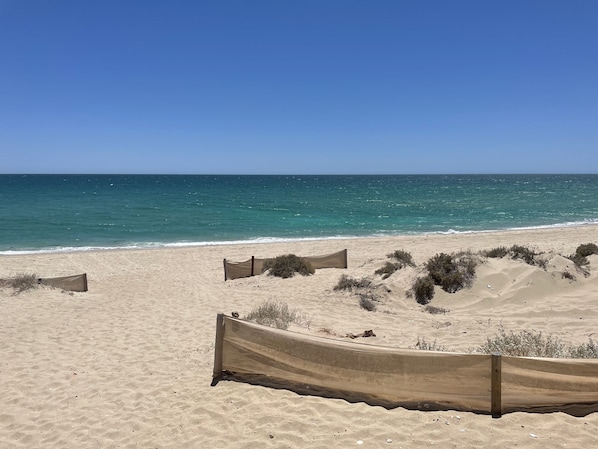 On the beach, sun-loungers